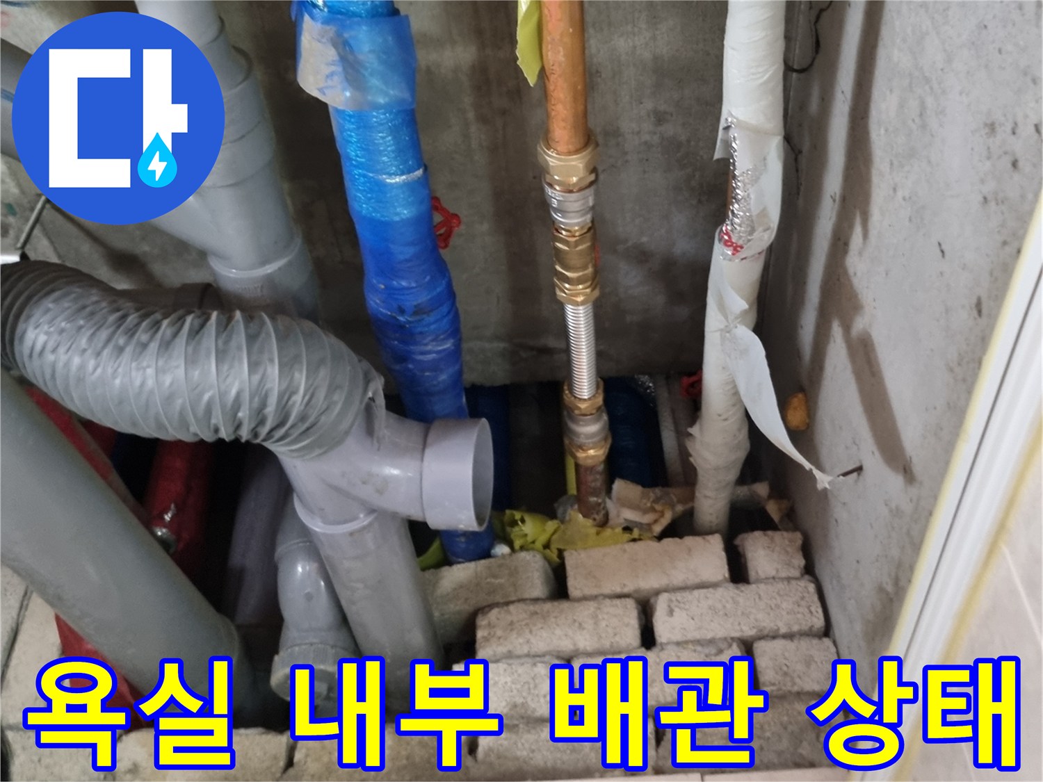 양주시 장흥면-욕실 벽면 하부의 부식된 금속 배관과 노후된 연결 부위 모습