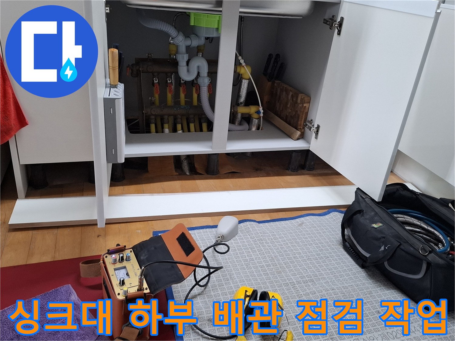 싱크대 아래쪽 난방 분배기와 연결된 노란색 엑셀 파이프 및 검사 장비
