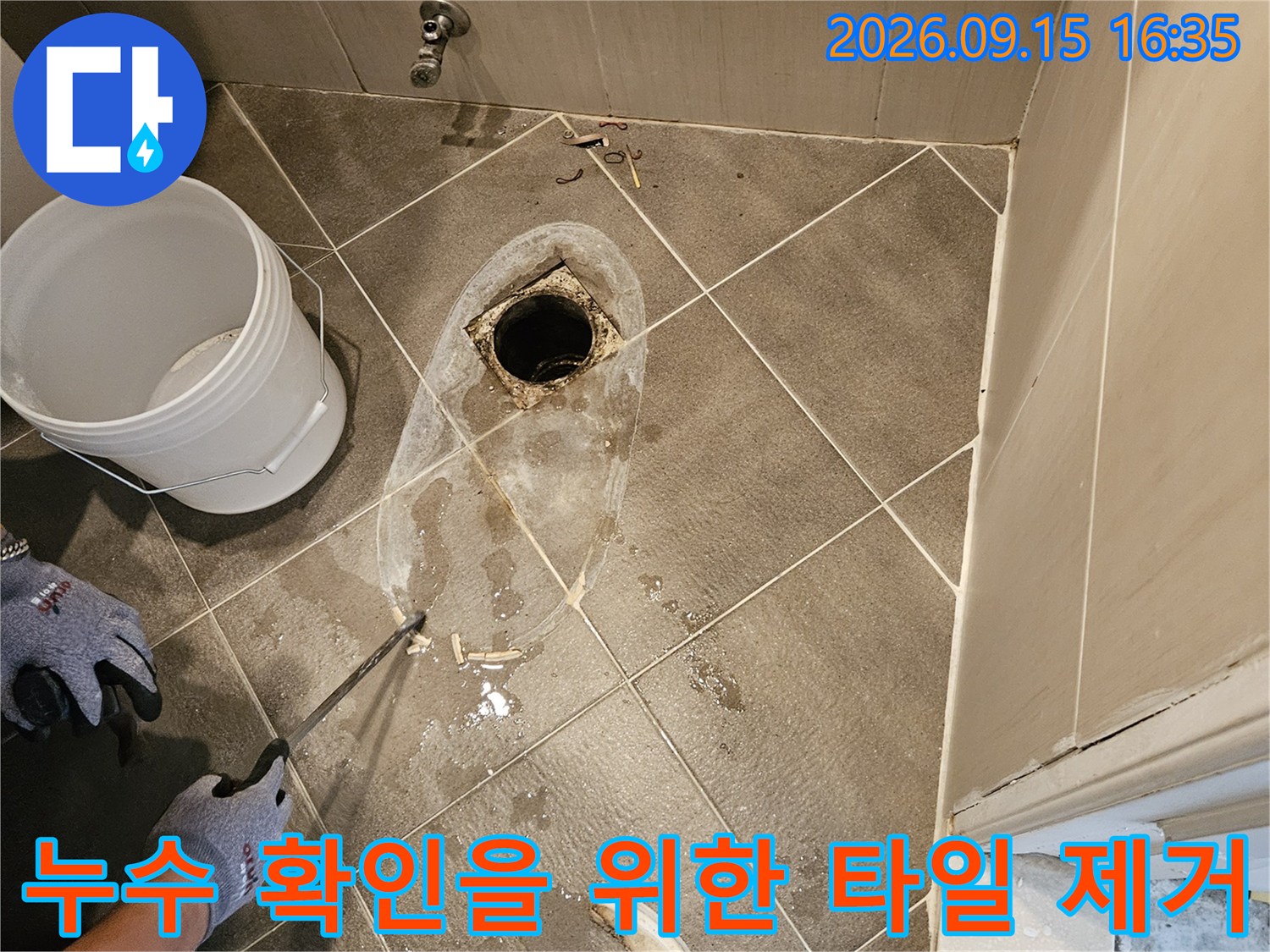 화장실 바닥 작업-배수구 주변의 굴착된 공간과 타일 파편